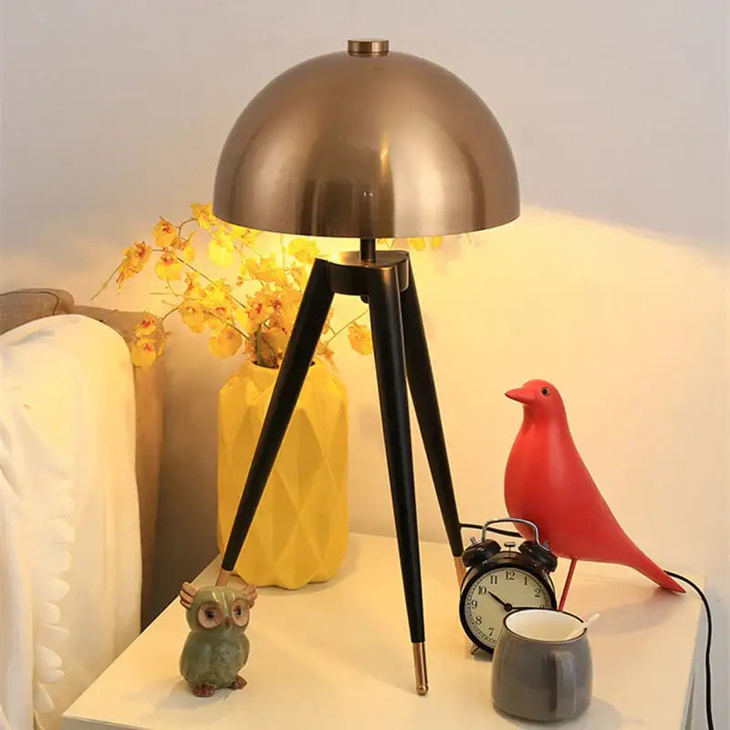Modern gold and black tripod floor lamp with brass dome shade for decorbites coyote living room decor