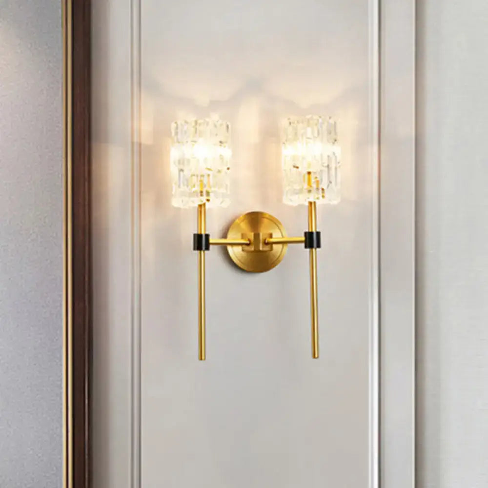 Modern gold and black wall sconce with gold finish and two crystal-encased light fixtures for living room wall light