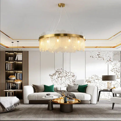 Modern gold and blue glass chandelier with frosted glass pendants is an elegant dining table lighting solution