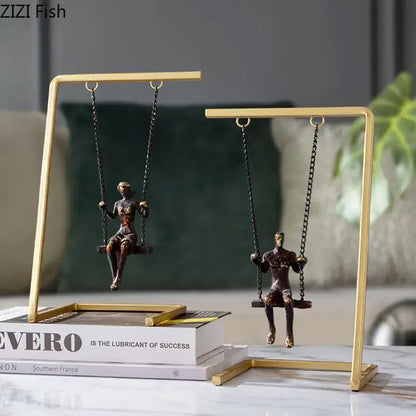 Modern gold and bronze swing metal sculpture featuring bronze figurines on gold-toned stands for living room decorbites golden swing