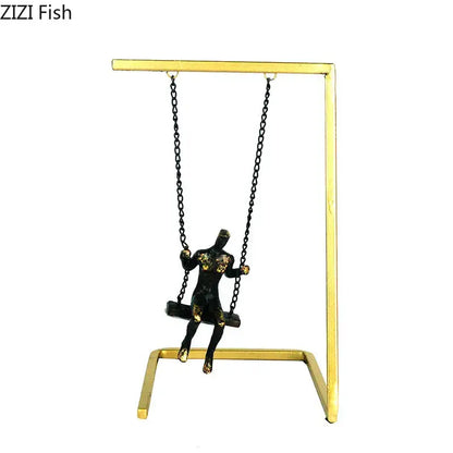 Black and gold modern golden swing metal sculpture mounted on golden metal stand for living room decorbites decor