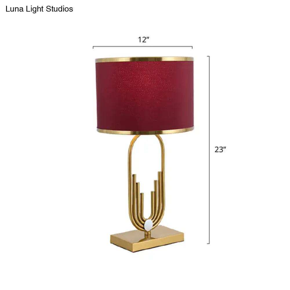 DecorBites™ red fabric drum nightstand lamp with a gold-toned base and textured burgundy shade for bedside lighting