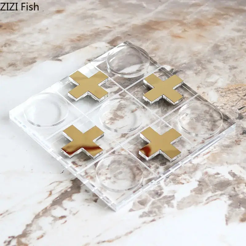 Modern gold and clear acrylic tic-tac-toe chessboard set with gold mirrored x and clear o markers for living room decor