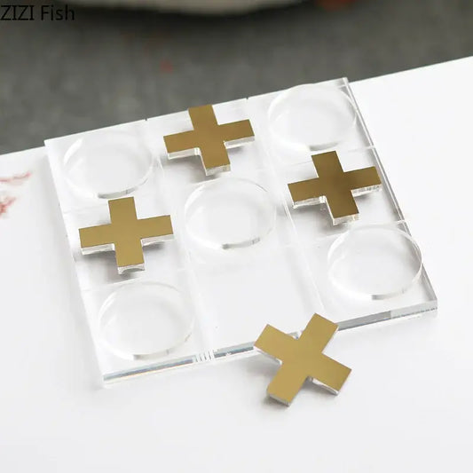 Modern gold and clear acrylic tic-tac-toe chessboard set with gold cross markers for stylish living room decor