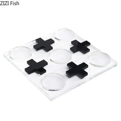 Modern gold and clear acrylic tic-tac-toe chessboard set with black cross and transparent circular markers for living room decor
