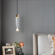 A modern pendant light with gold-toned top and clear crystal copper body by Decorbites for dining room decor