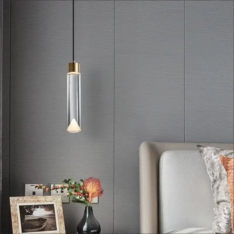 A modern pendant light with gold-toned top and clear crystal copper body by Decorbites for dining room decor