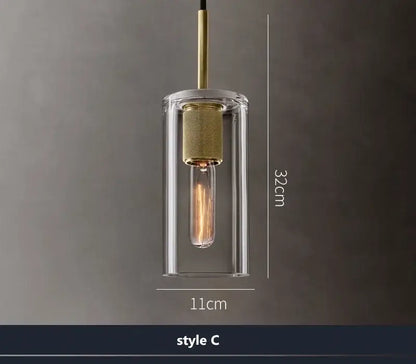 Modern gold and clear glass led pendant light with cylindrical shade and brass accents for dining room lighting