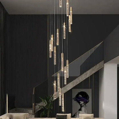 Modern gold and crystal cylindrical stair chandelier with vertical crystal rods and warm light by decorbites cylindrical stair