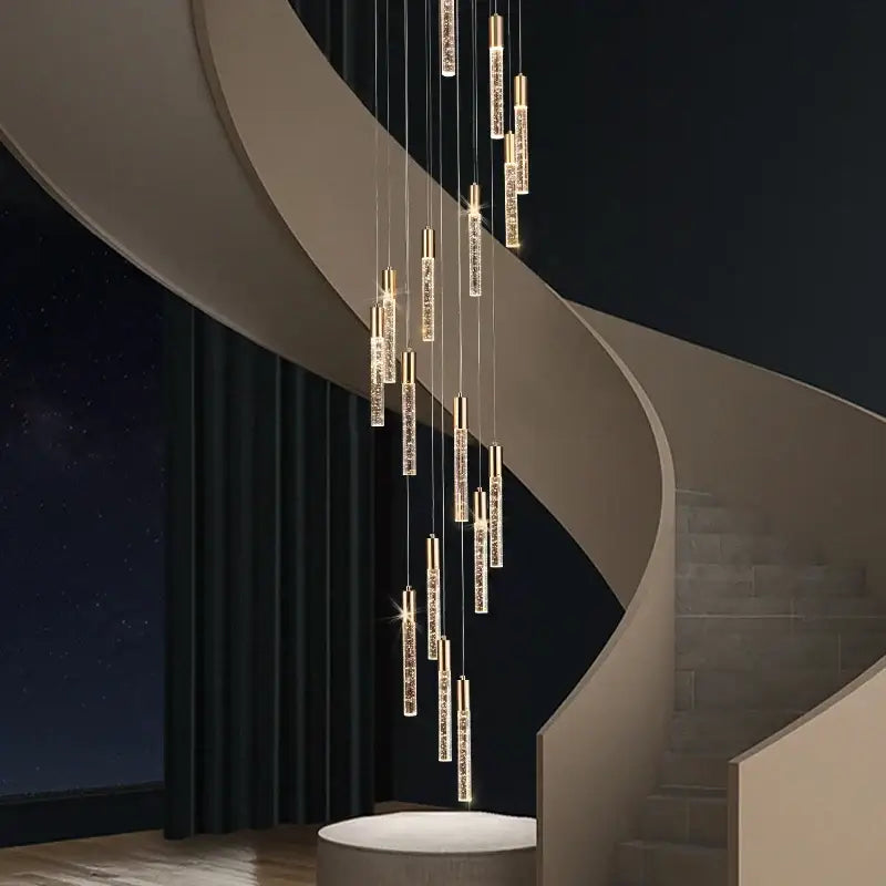 Modern gold and crystal cylindrical stair chandelier with sleek decorbites cylindrical stair design above curved staircase