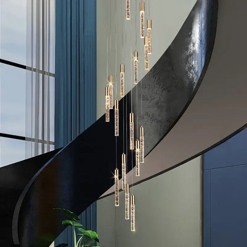 Modern gold and crystal cylindrical stair chandelier with cascading slender lights ideal for living room decorbites cylindrical stair