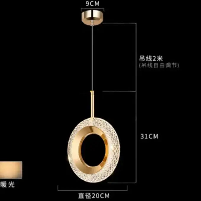 Modern gold and crystal oval bedside pendant light with gold-toned circular textured crystal outer ring and polished frame
