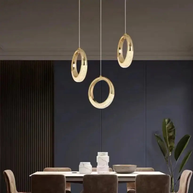 Three modern gold-toned circular bedside pendant lights with crystal accents for bedroom pendant light decor