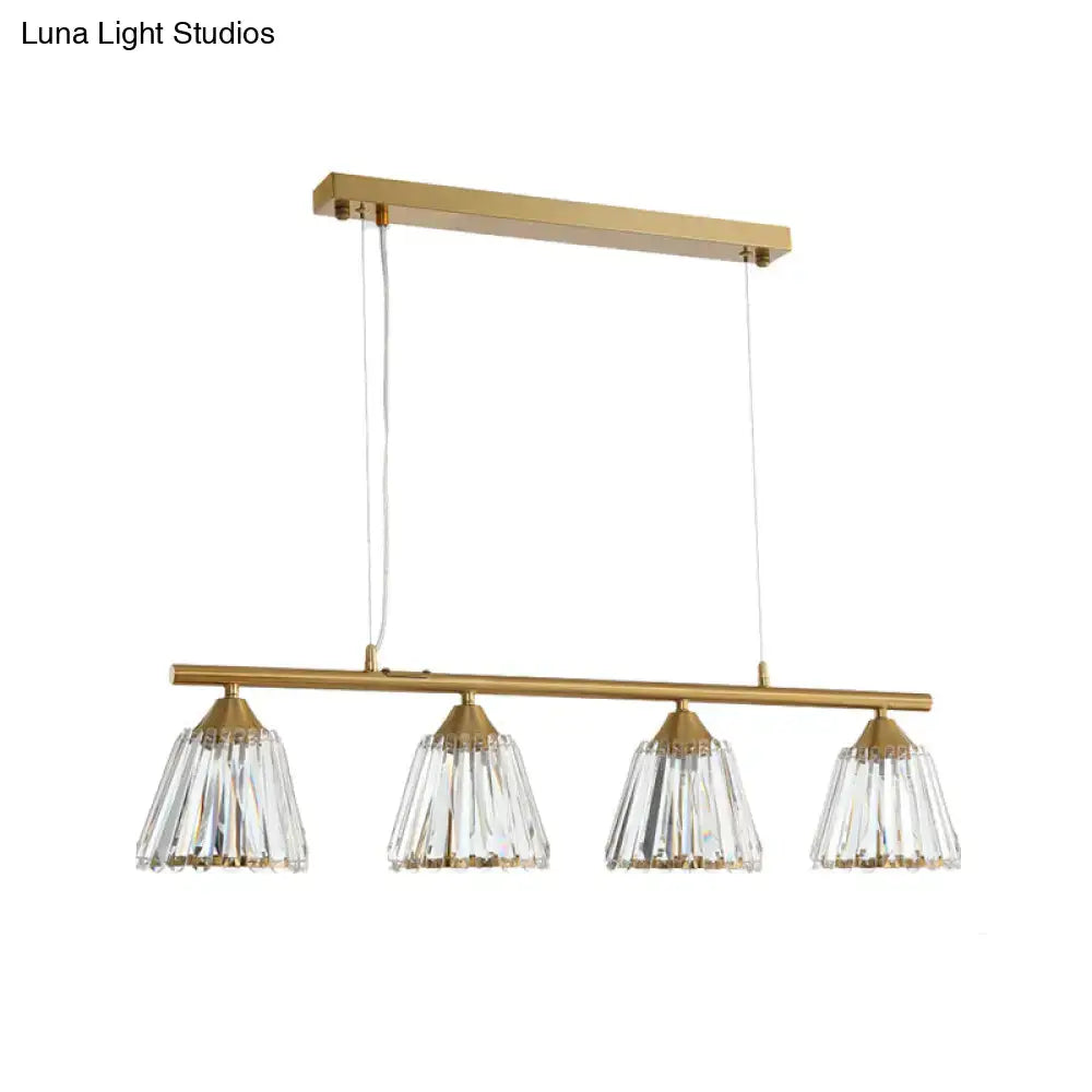 Modern gold and crystal pendant light with four clear faceted shades on a horizontal bar for 220v-240v use