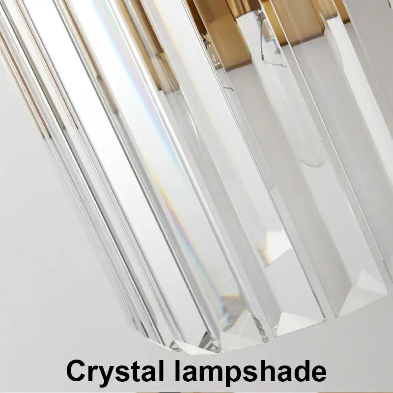 Modern gold and crystal wall light featuring a clear faceted crystal lampshade with gold-toned metallic accents decorbites crystal wall