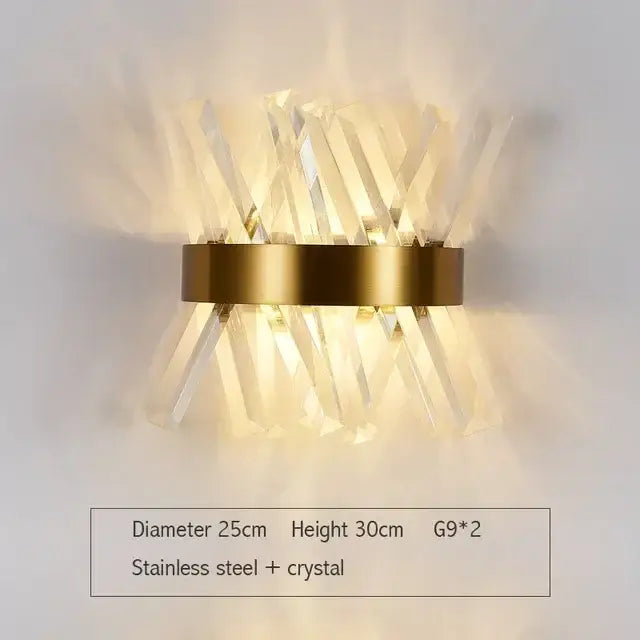 Modern gold and glass led wall lamp with a circular stainless steel base and clear crystal prisms for bedroom use