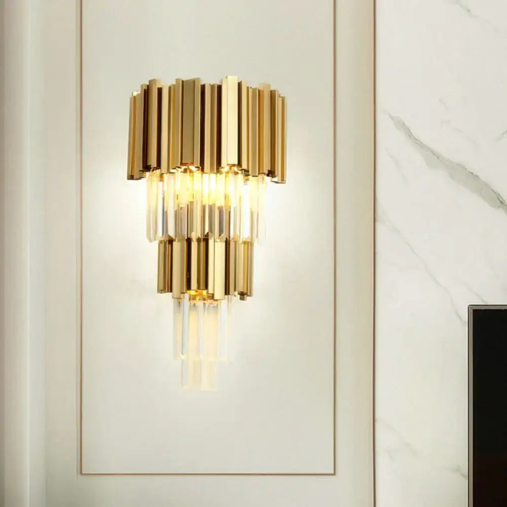 Modern gold and glass led wall lamp with tiered vertical bars and hanging crystal accents for bedroom use