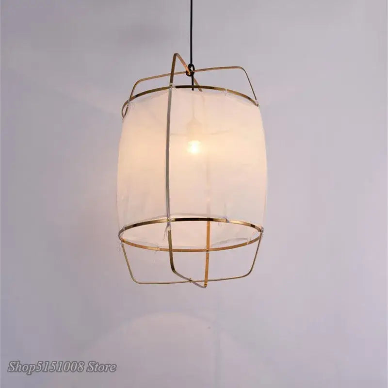 Modern gold and glass pendant light fixture with brass wireframe and bamboo linen shade for dining room decorbites