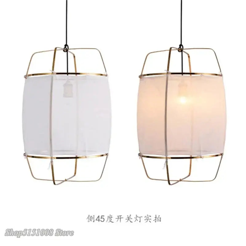Modern pendant light fixture with brass-colored cylindrical frame and translucent bamboo linen shade for dining room decorbites