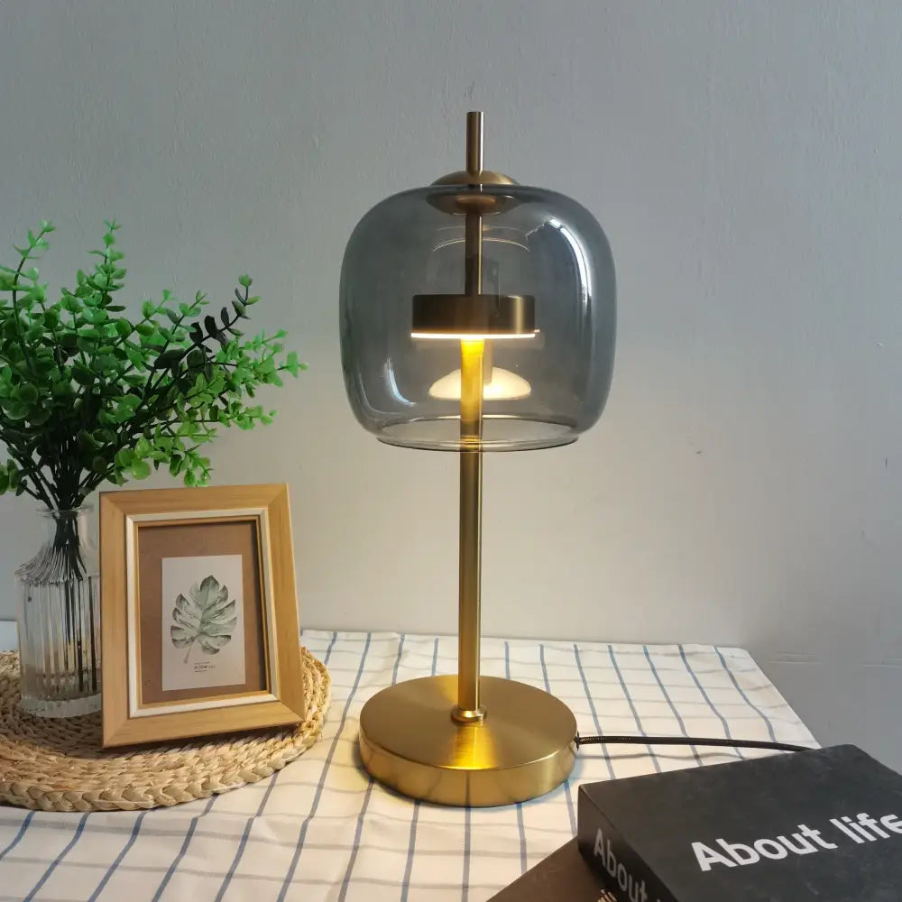 Modern gold and gray glass table lamp with brass finish and rounded smoked glass shade for bedroom decorbites decorbites glass table lamp