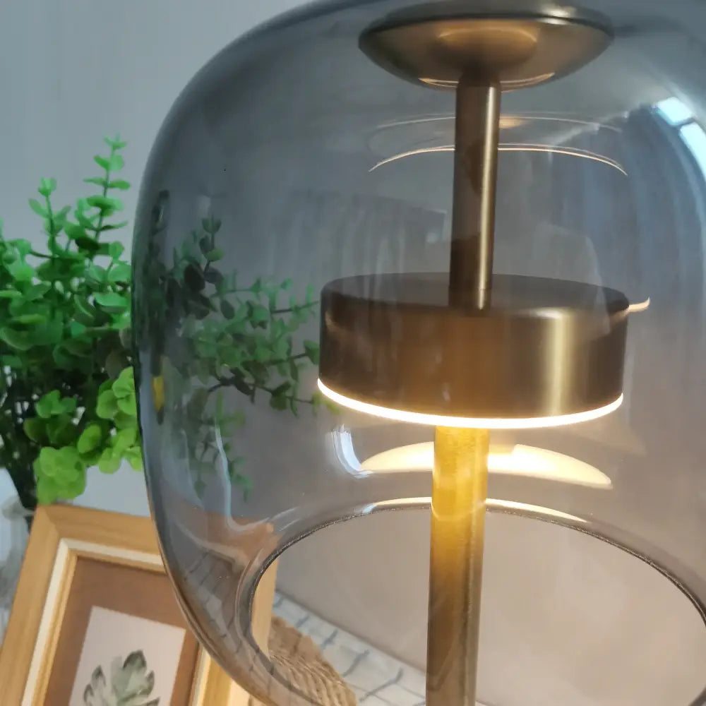Modern gold and gray glass table lamp with translucent dome and illuminated ring for decorbites glass table lamp decor