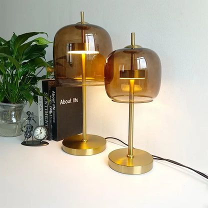 Two amber glass table lamps with brass bases in modern design ideal for bedroom decorbites glass table lamp use
