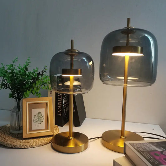 Modern gold and gray glass table lamp set featuring gold-finished bases and translucent gray glass domes for bedroom use