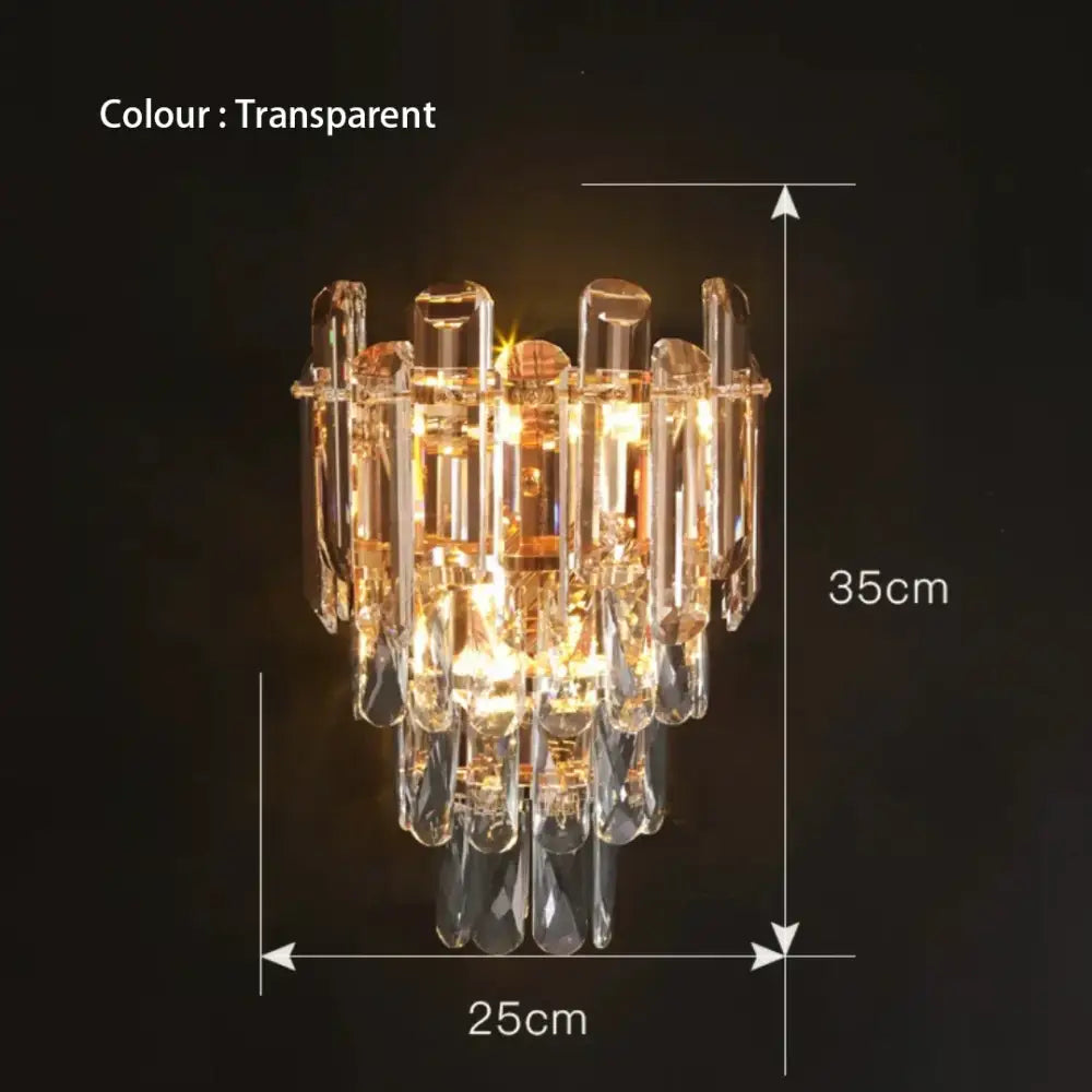 Transparent crystal chandelier with tiered design and teardrop crystals paired with modern gold and gray glass wall lamp