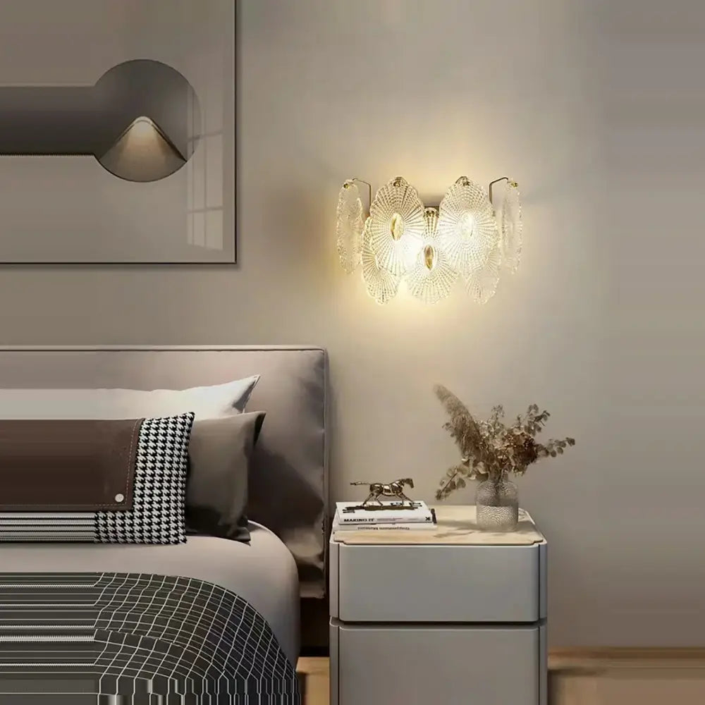 Modern gold wall lamp with gray glass wall leaf sconce and translucent petal-shaped shades emitting warm light