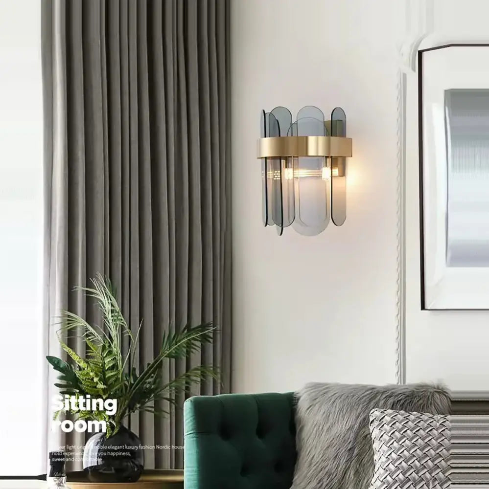 Modern gold and gray glass wall lamp with translucent fan-like glass panels designed as a leaf sconce for living rooms