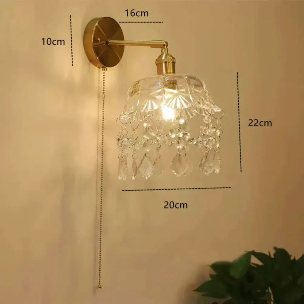 Modern gold wall lamp featuring a clear faceted crystal shade and gray glass wall sconce for living room use