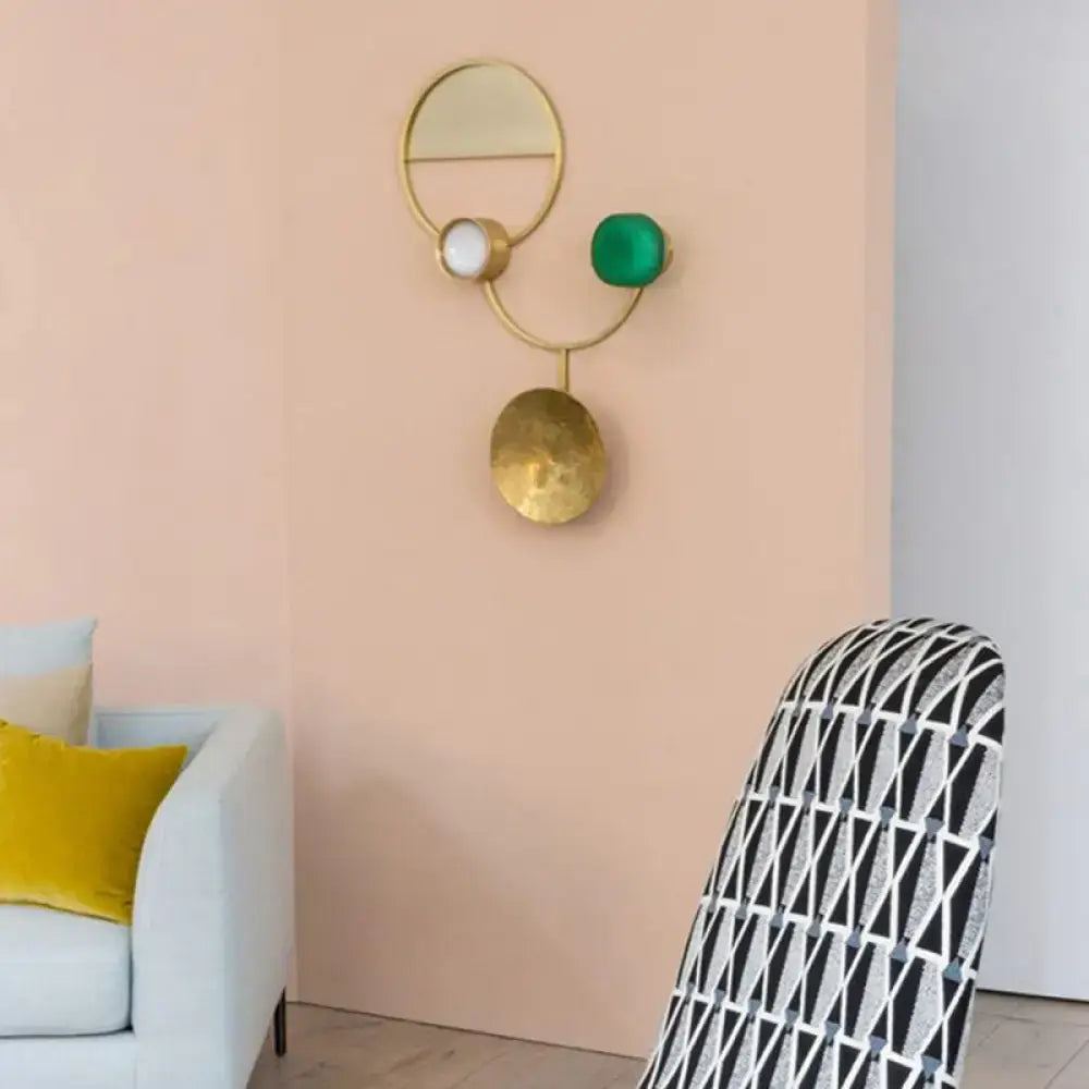 Modern gold and green orbit wall sconce wall lamp with geometric design, circular mirror, and hammered disc base