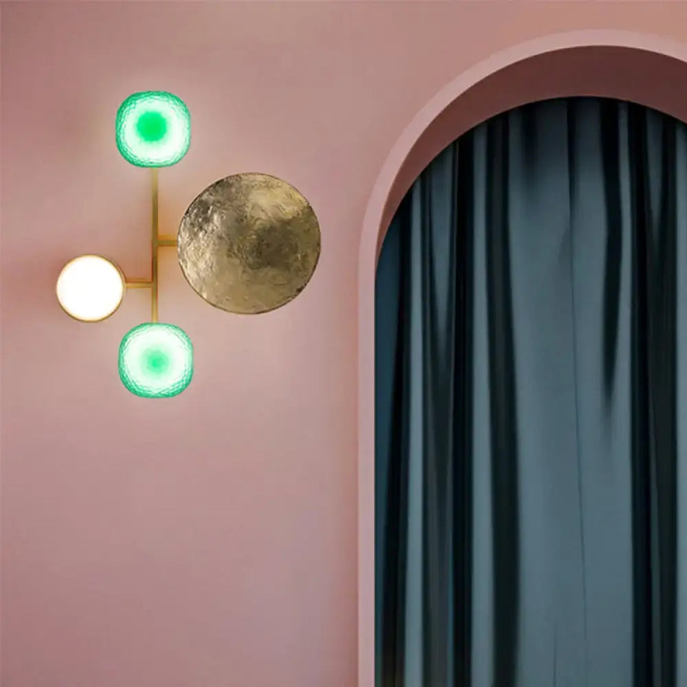 Modern gold and green orbit wall sconce with a gold metal frame and three circular lights for bedroom wall lamp use