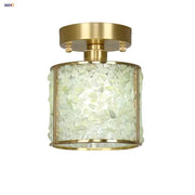 Modern gold ceiling light with a pale green glass mosaic cylindrical shade featuring decorbites copper canopy led design