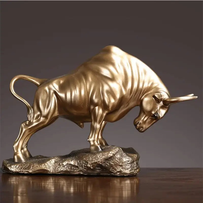 Modern gold and silver decorbites bull sculpture featuring a golden metallic bull figurine on a rocky base office decor