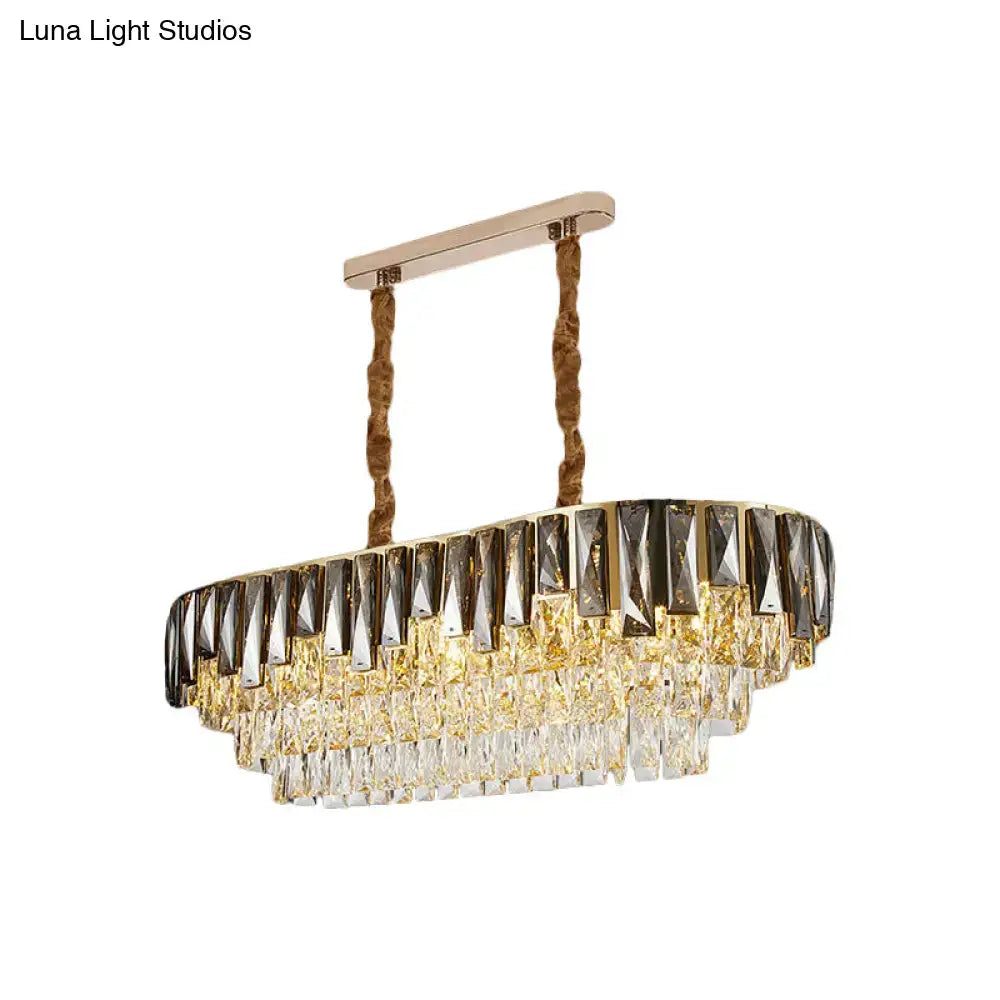 Gold-toned rectangular chandelier with tiered smoke grey crystal accents and twisted rope suspension by DecorBites