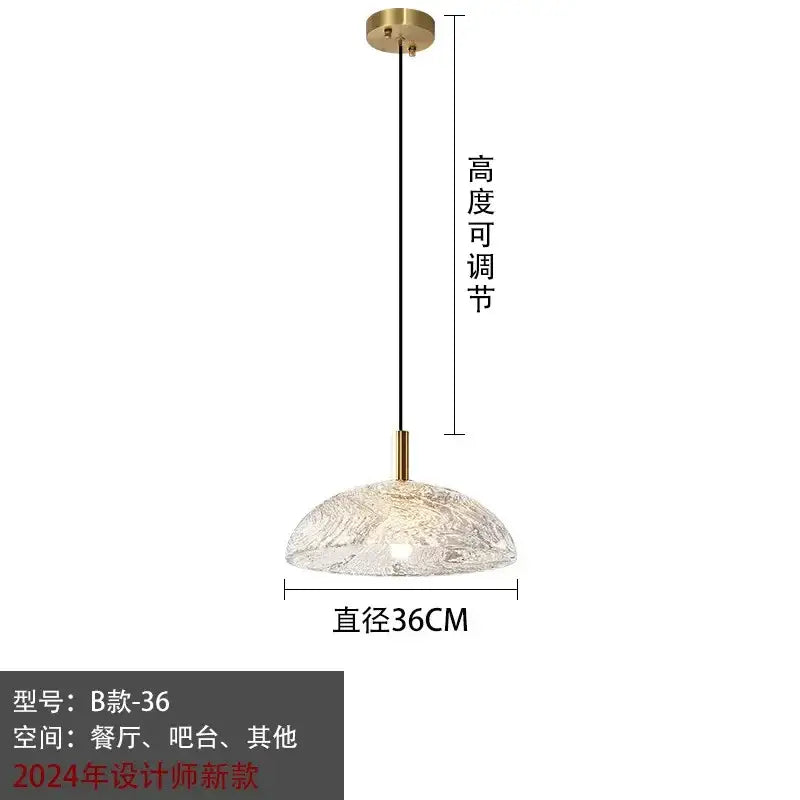Modern gold glass pendant light with textured translucent dome and brass accents for kitchen and dining room