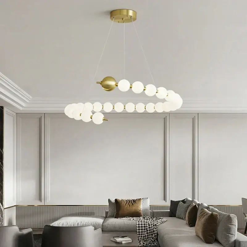Modern gold and white acrylic led chandelier with gold-toned spiral design and frosted glass globe bulbs by decorbites acrylic led