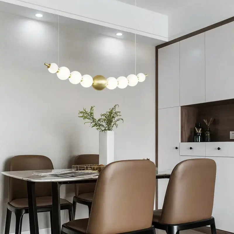 Modern gold and white acrylic led chandelier with spherical bulbs by decorbites acrylic led above dining table