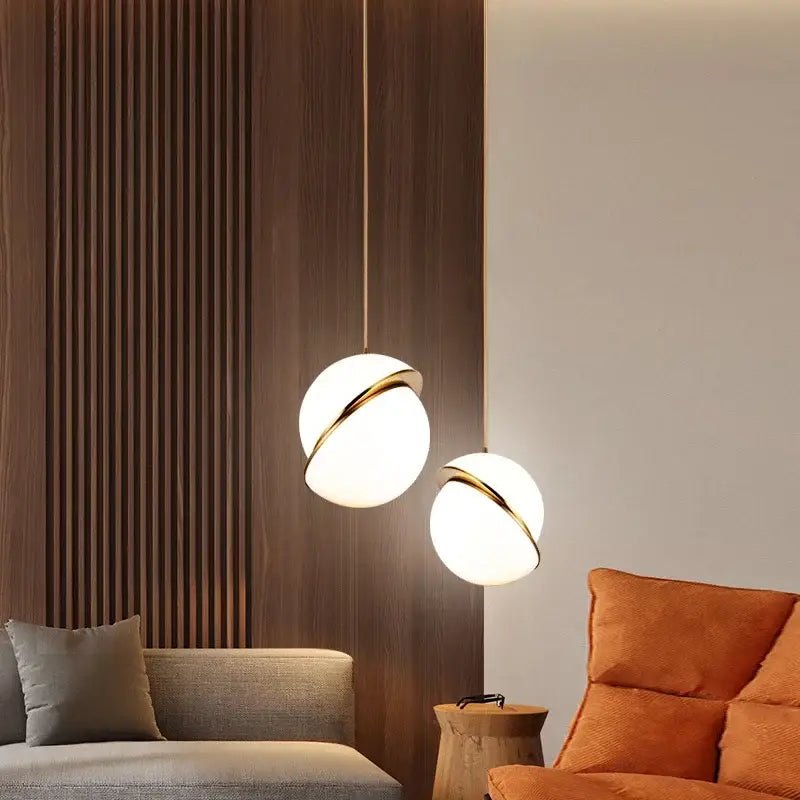 Two modern pendant lights with frosted glass spheres and gold-toned rings decorbites golden ball pendant decor