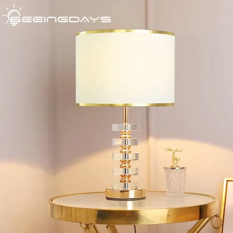 Modern gold and white crystal table lamp with stacked crystal tiers and fabric shade ideal for bedroom decorbites crystal table lamp