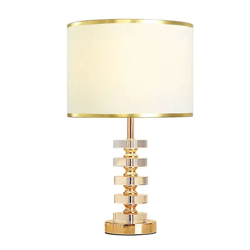 Modern gold and white crystal table lamp with cream fabric shade and stacked crystal rings base for bedroom decorbites decor