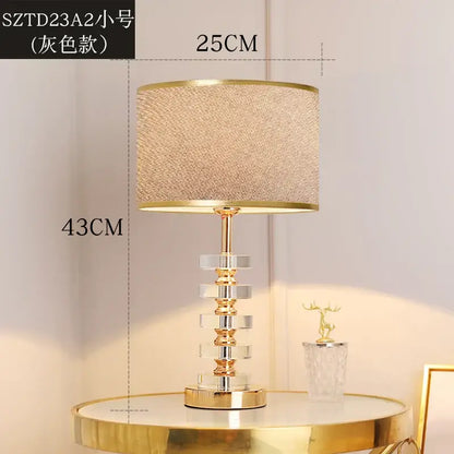 Modern gold and white crystal table lamp with textured beige fabric shade and stacked crystal tiers for bedroom decorbites crystal table lamp