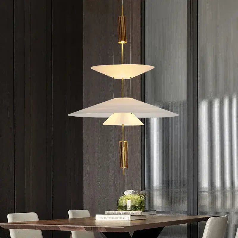 Modern gold and white pendant light with gold-toned metal accents and white glass shades by decorbites designer saucer ufo