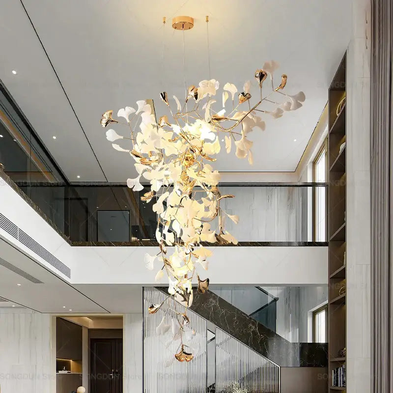 A modern gold and white gingko leaf ceramic chandelier with delicate metallic leaves for living room decorbites lighting