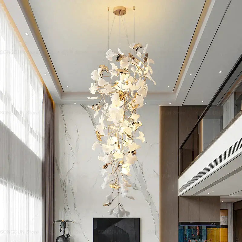 A modern gold and white gingko leaf ceramic chandelier with delicate leaf-like elements for living room decorbites decor