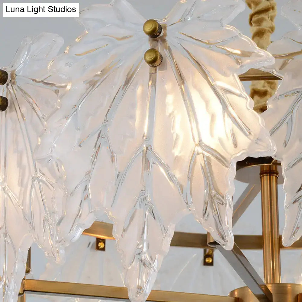 Modern gold and white glass floral pendant light fixture with clear molded glass leaves for dining room lighting