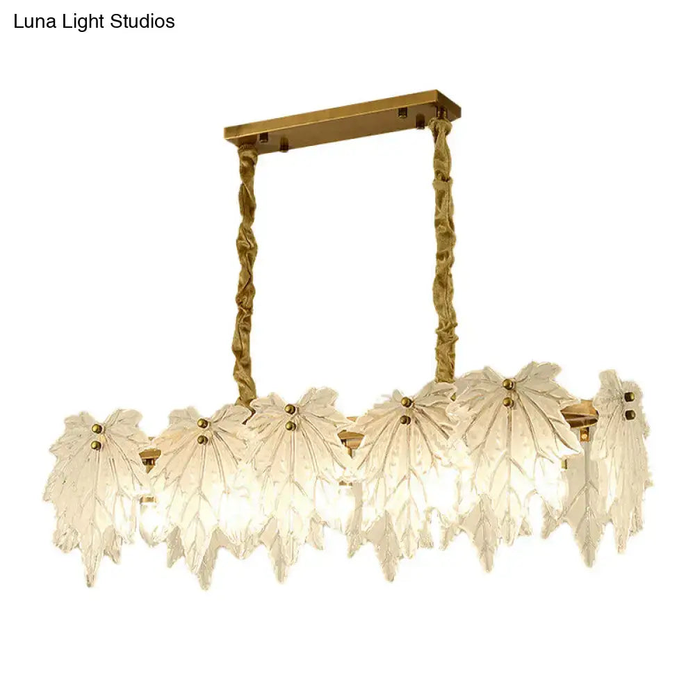 Modern gold and white glass floral pendant light fixture with leaf-shaped white glass shades for dining room use