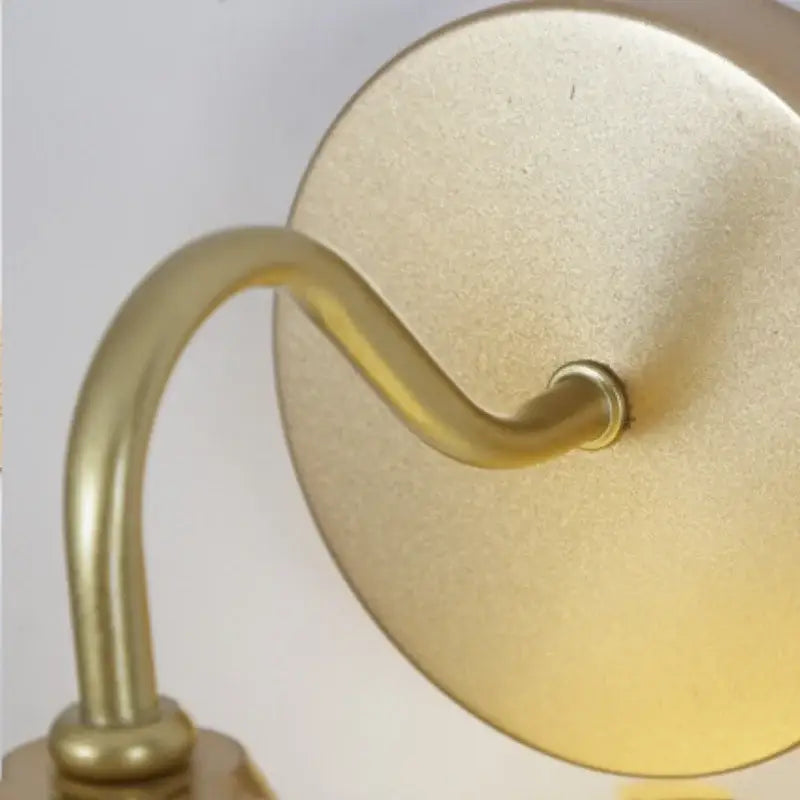 Modern gold and white glass wall lamp with gold-finished brass curved arm and circular backplate for stair light decorbites iron white