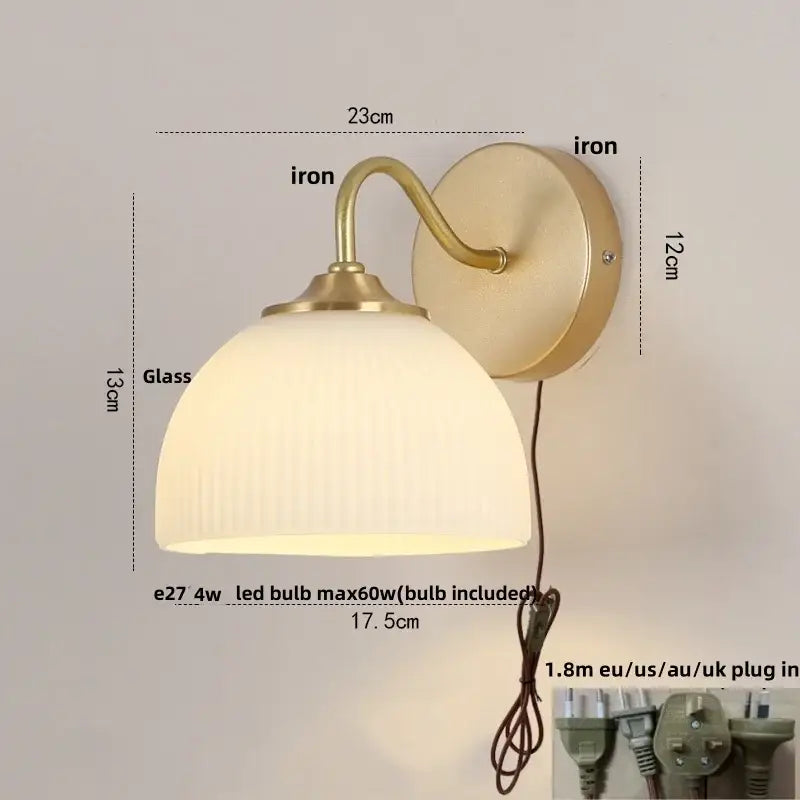 Vintage-style wall lamp with brass-finished iron frame and ribbed off-white white glass shade by decorbites iron white